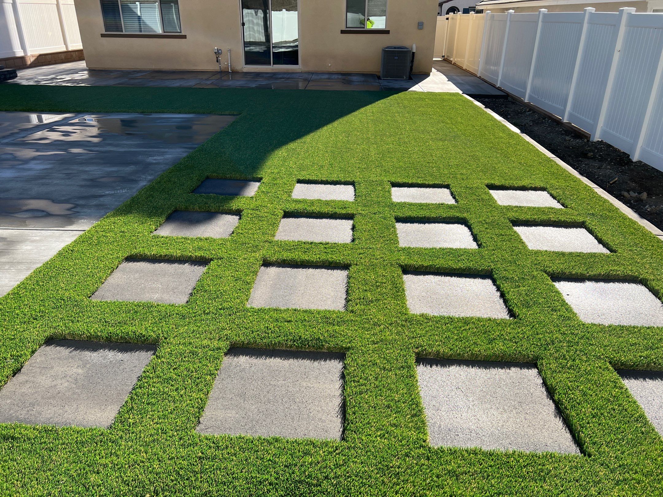 Backyard turf with checkerboard stepping stones