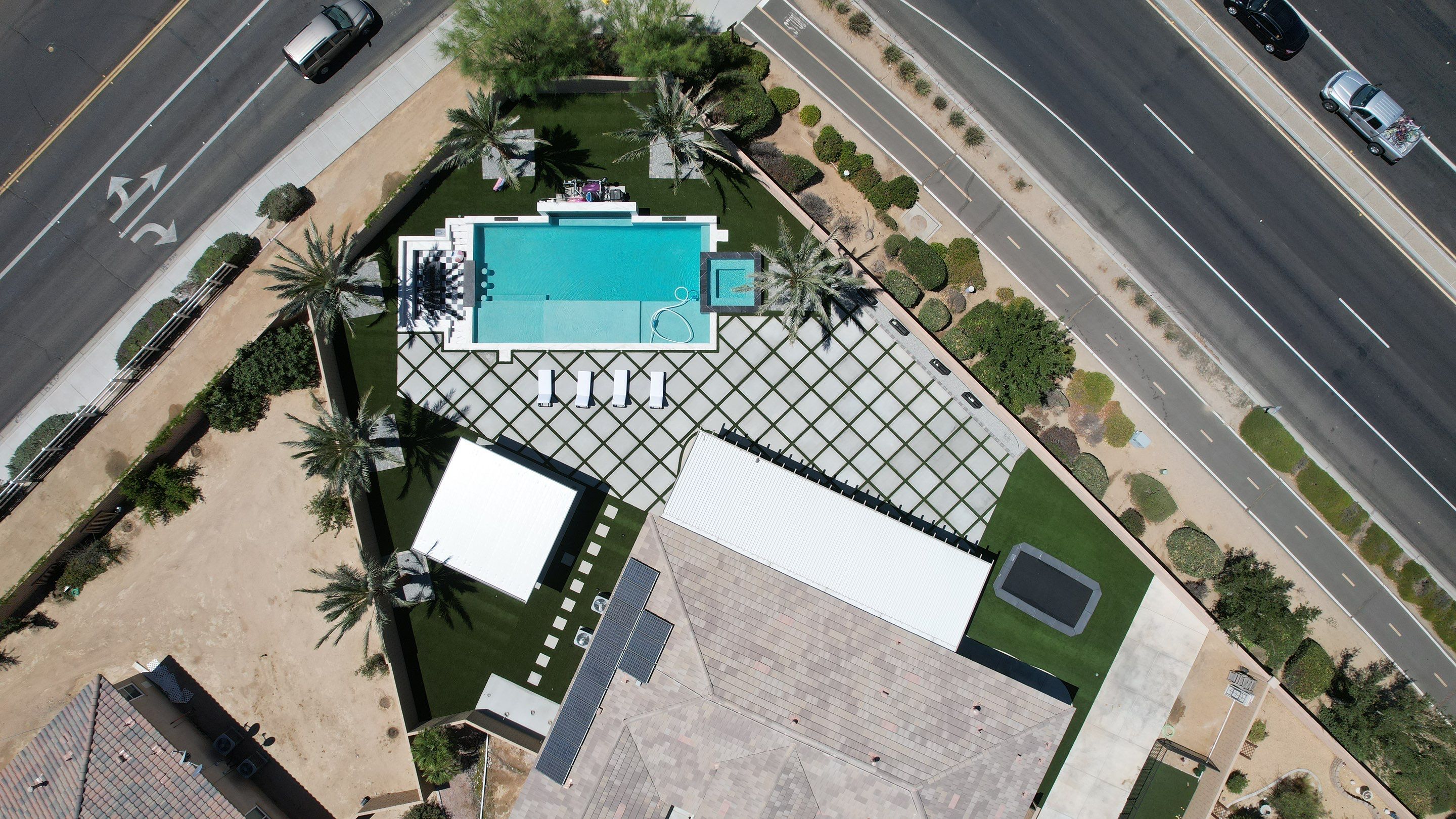 Drone view of luxury property with diamond-pattern Mighty Turf install by Monarch Landscape Design